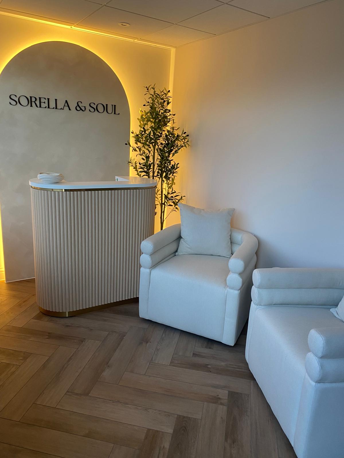 The Sorella & Soul reception, with the backlit arch and lounge chairs